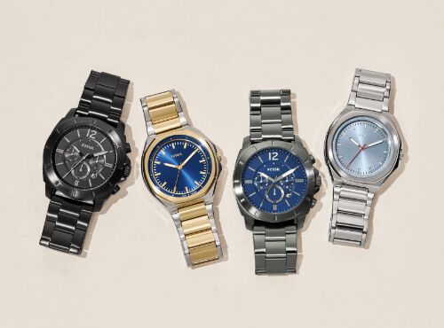 A groupshot of four men's watches with leather and stainless steel straps.