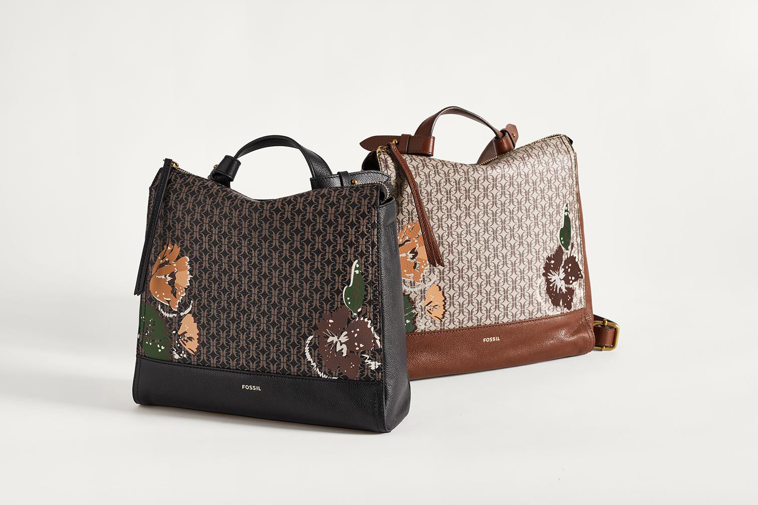 Two leather women's handbags with floral patterns.