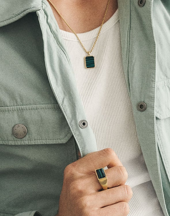 Zoom on a man wearing the Reconstituted Green Malachite necklace and ring