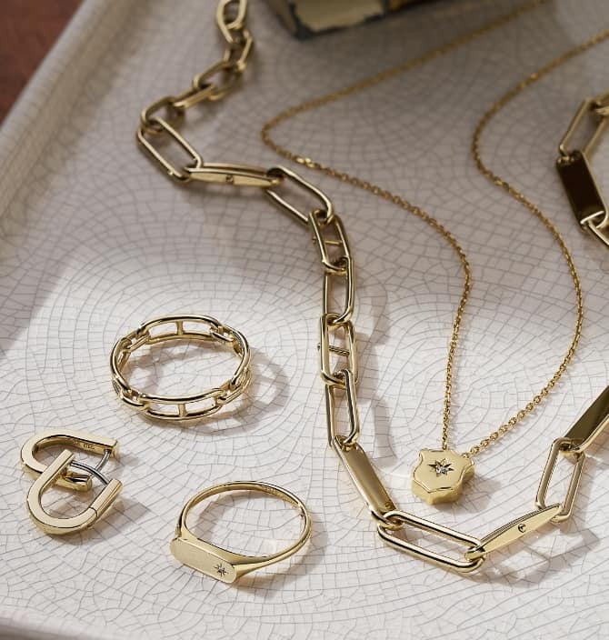 A group shot of the gold-tone Fossil Heritage jewellery, including rings, bracelets, earrings and necklaces. 