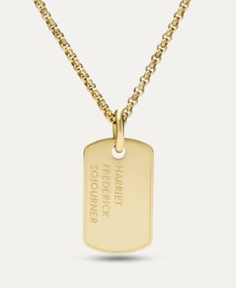 A gold-tone limited-edition necklace inscribed with the word Heroes and first names of important Black historical figures on the back.