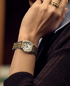 A lifestyle image of a woman wearing the Harlow watch with a green leather strap.