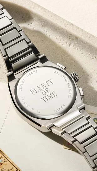 A Fossil watch caseback with a personalized engraving.