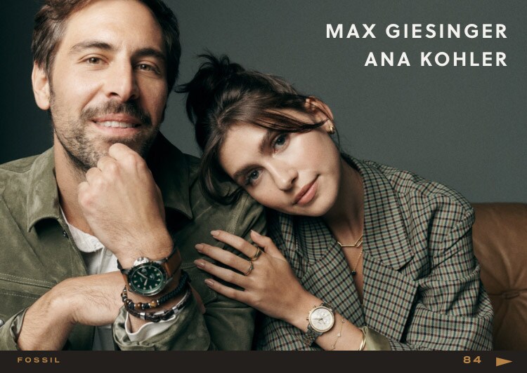 Ana and Max are sitting. They're wearing different Fossil products.