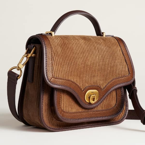 A brown suede Fossil heritage handbag.
