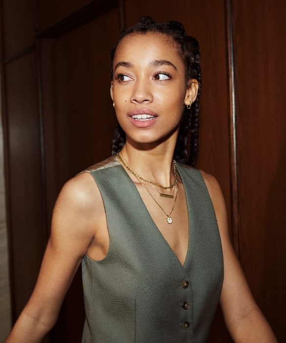 A woman wearing gold-tone Fossil Heritage Jewellery.