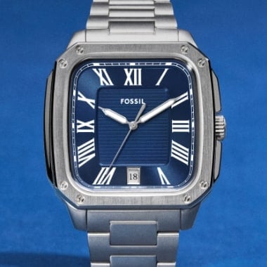A man wearing a silver-tone watch.
