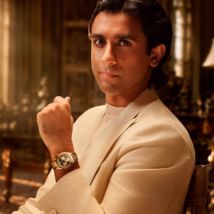 Photo of His Highness wearing a silver-tone Signature automatic watch with a black dial.