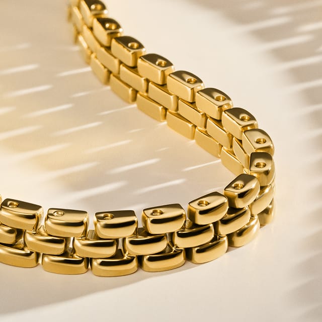 A gold-tone chain necklace inspired by watch links.
