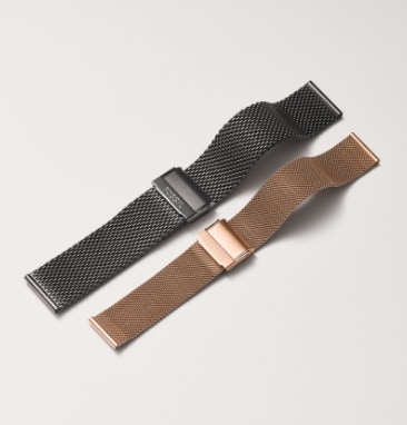 Two silver and rose gold-tone watch bands.