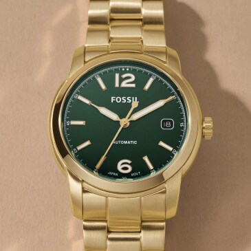 Image of a gold Fossil watch with a green face.