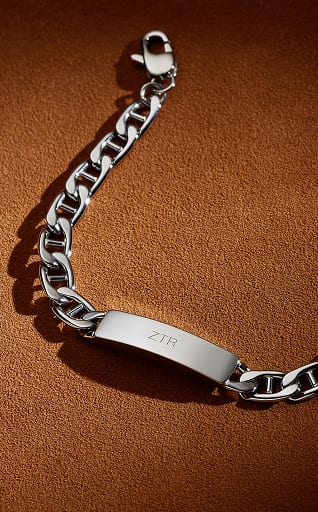 A stainless steel chain bracelet featuring an engravable ID plate.