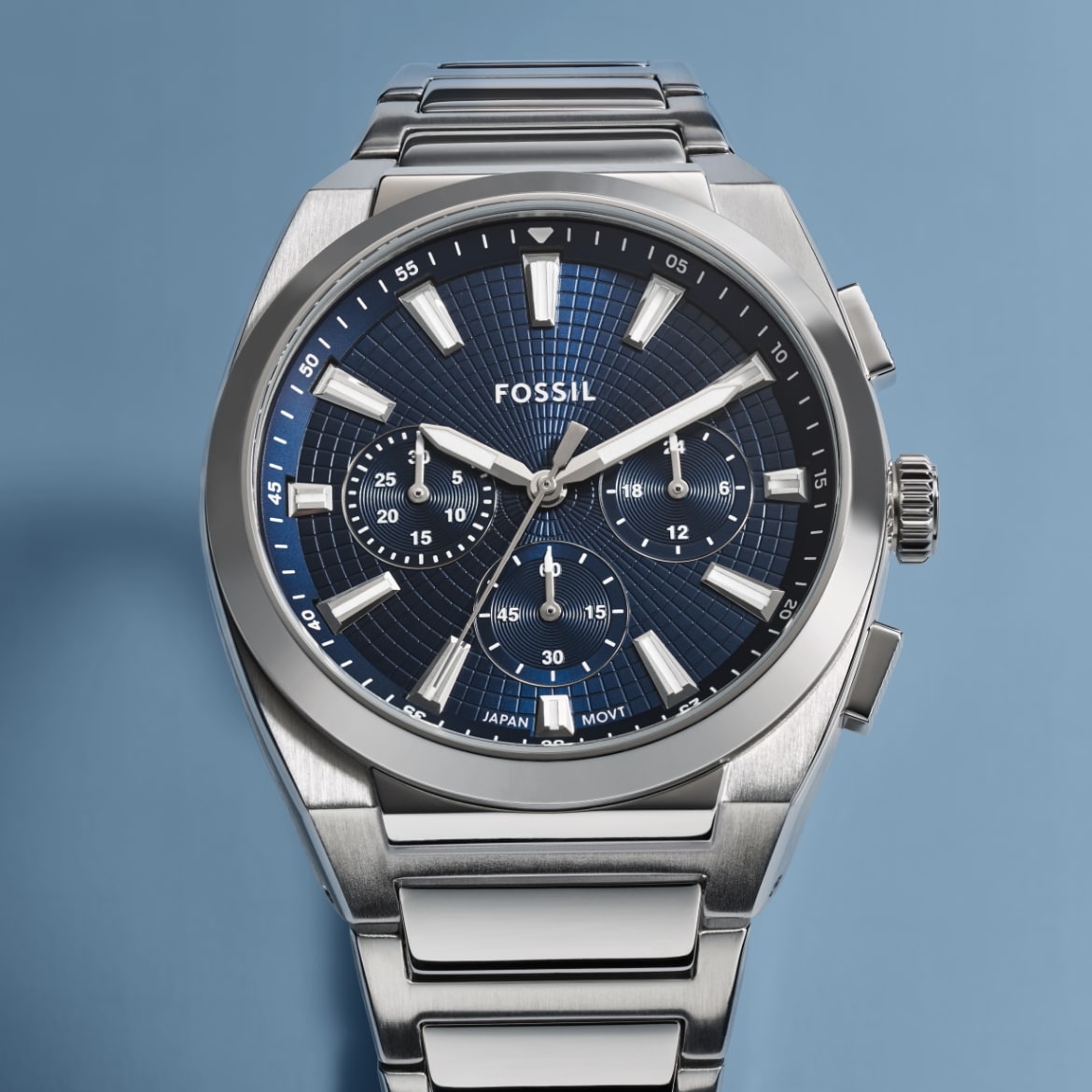 A men's sporty watch in a silver-tone finish with a round case and a dark blue dial.