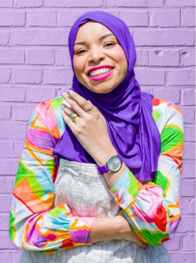 A photo of Blair Imani wearing a Pride Watch case on a purple strap.