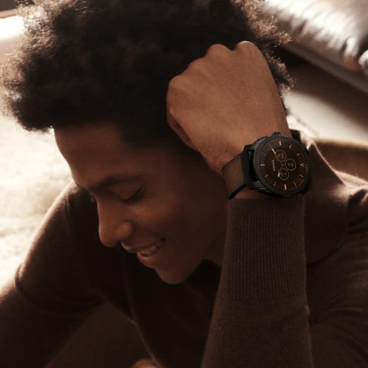 A man wearing a Gen 6 Hybrid smartwatch.