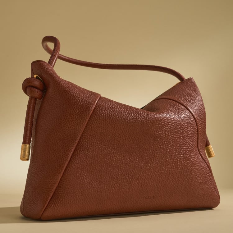 A women's shoulder bag in tan pebbled leather.
