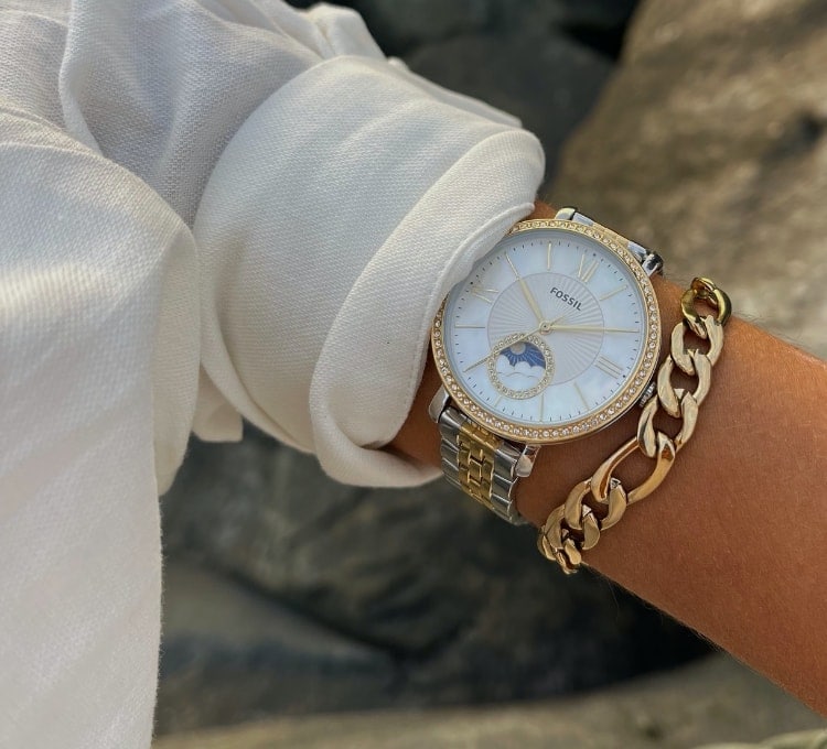 A close-up of the gold-tone Celestial watch with a gold-tone bracelet.