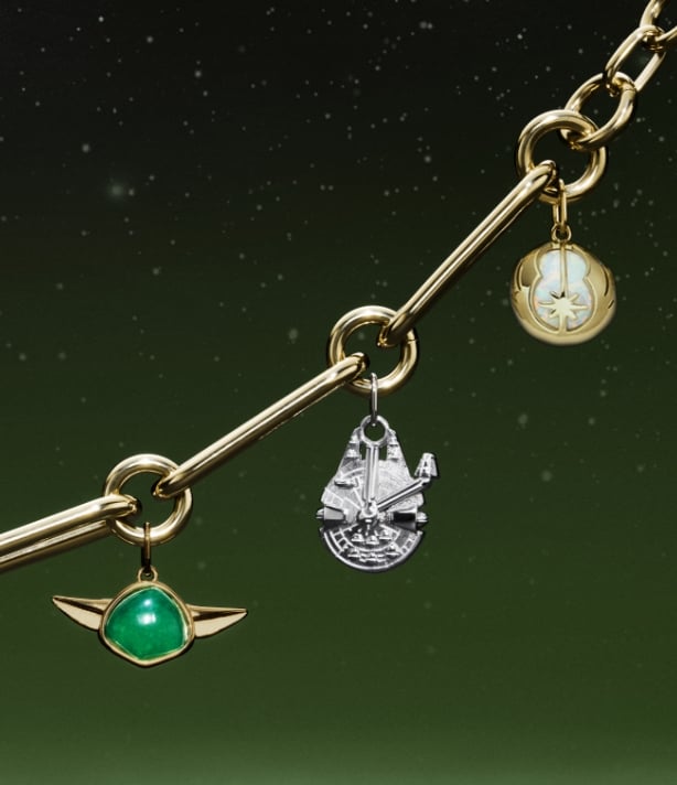 A gold-tone bracelet with charms shaped like Yoda, the Millennium Falcon, C-3PO, R2-D2 and a Lightsaber