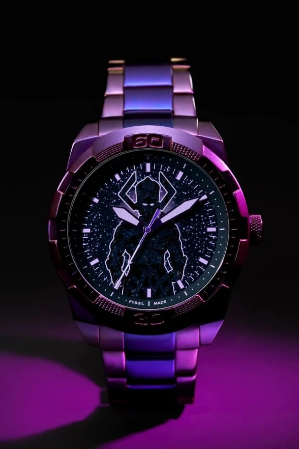 Blurred view of a round oversized watch silhouette on a glowing purple intergalactic background.