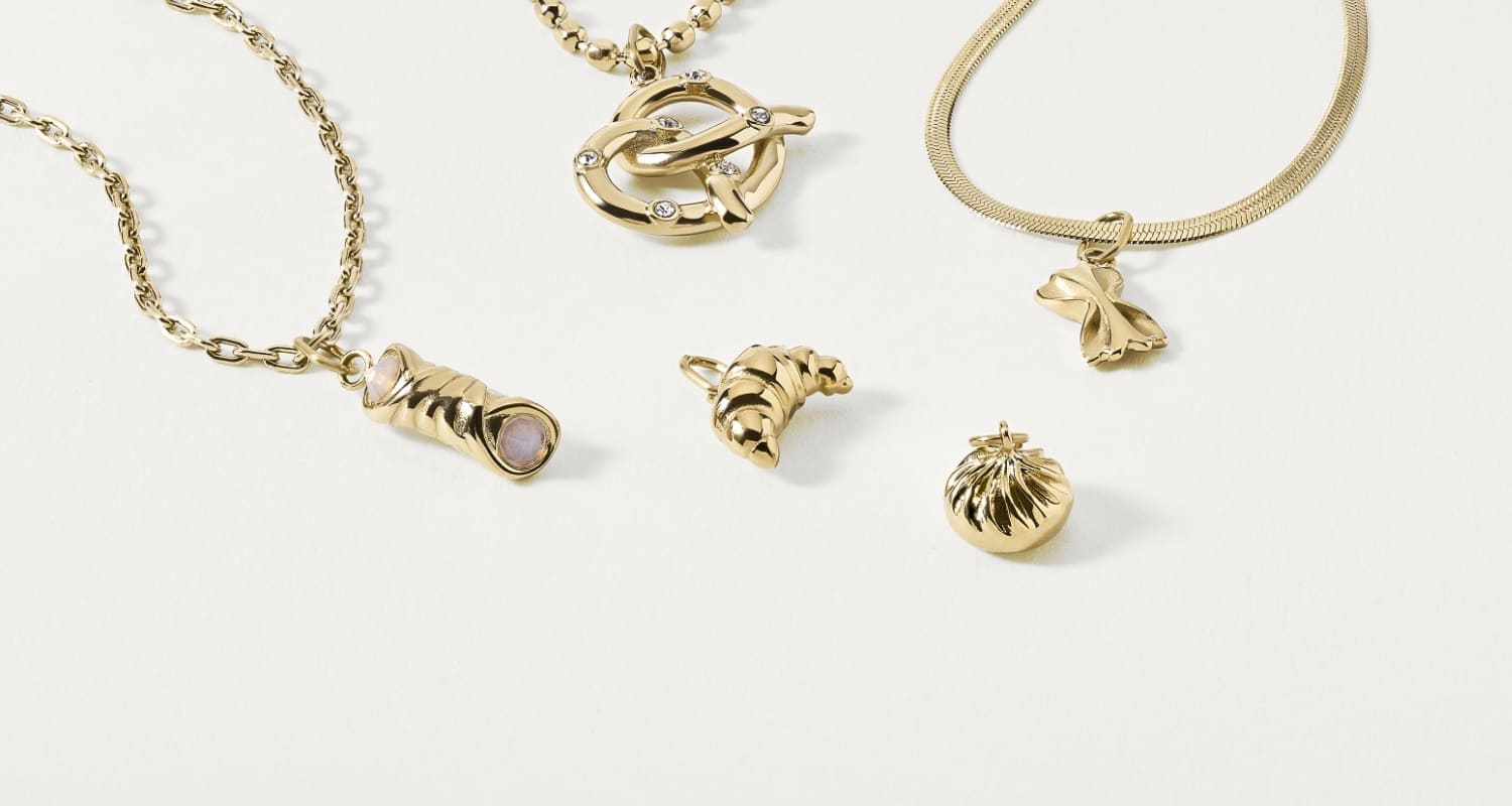 Charm Shop. Four charms and a gold-tone chain.