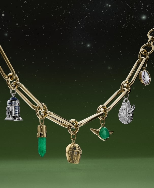 A gold-tone bracelet with charms shaped like Yoda, the Millennium Falcon, C-3PO, R2-D2 and a Lightsabre