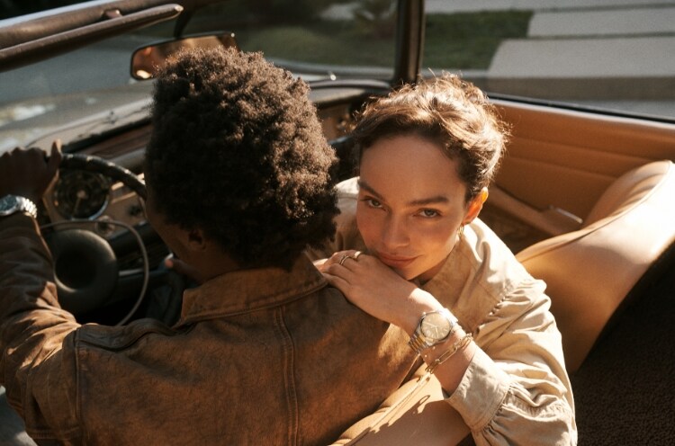 Man and woman in a car. Wearing a Fossil watch.