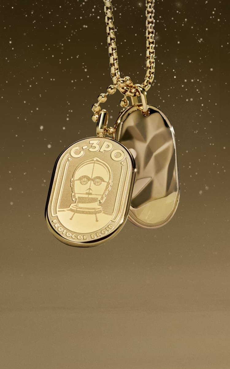 A gold-tone necklace with an engraving of C-3PO on an ID plaque