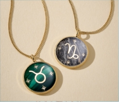 Two zodiac pendant necklaces.