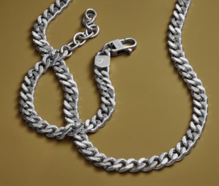 Two silver-tone men's chains.