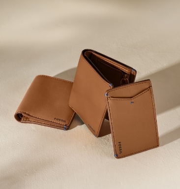 Three brown leather wallets.