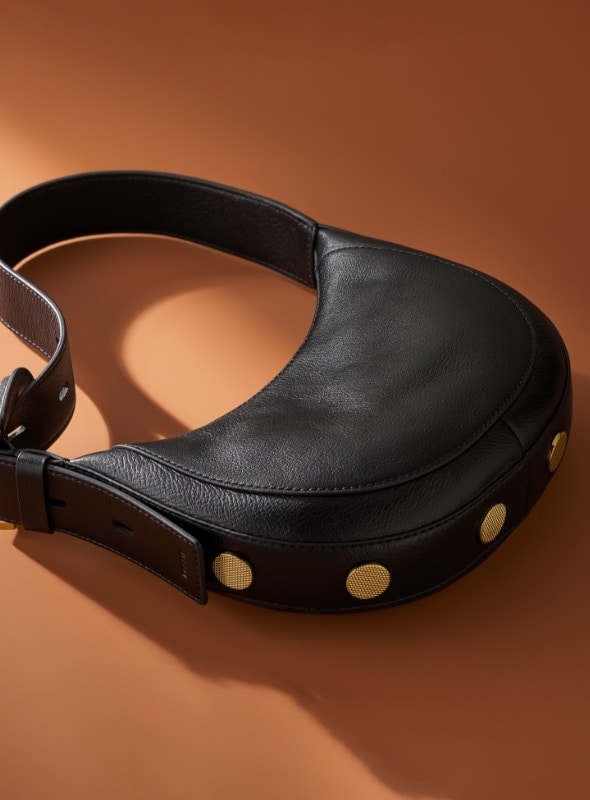 A small black crescent-shaped handbag with gold-tone hardware.