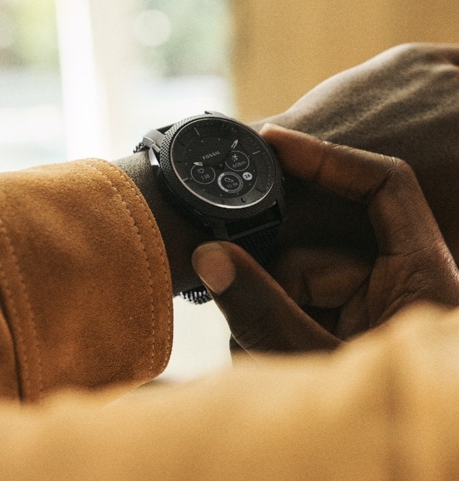 Man wearing black Gen 6 Hybrid smartwatch.