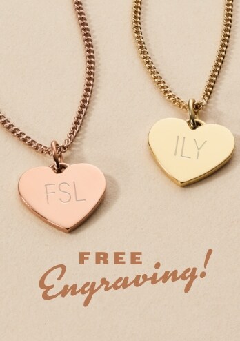 Two heart-shaped pendant necklaces with FSL and ILY engraved on them.