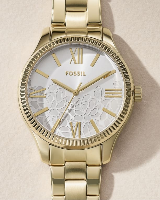A women’s watch with a small round dial, accented by a sparkling topring and bracelet.
