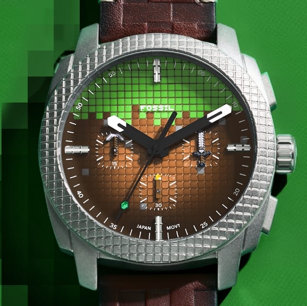 Une montre robuste pour homme conçue pour imiter le bloc d’herbe de Minecraft, comprenant un cadran vert et brun texturé en blocs, une lunette argentée et un bracelet en cuir brun marqué.