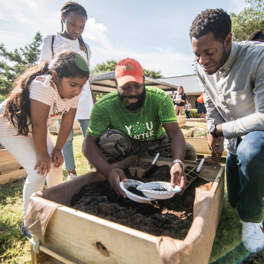 Children working in a raised garden bed