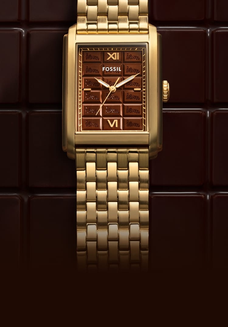 The gold-tone Carraway watch atop a chocolate bar-inspired background.