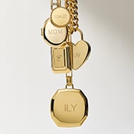 The caseback of a watch and necklace charm, waiting to be engraved.