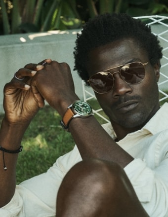 Man wearing a Fossil Blue watch with a brown leather strap.