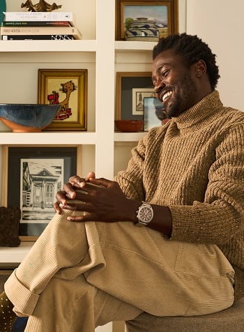 Stylish man in a tan turtleneck posing candidly in the rugged Machine chronograph.