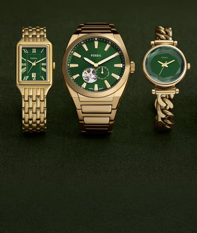 A variety of Fossil watches, each finished in a gold tone with a deep green dial.