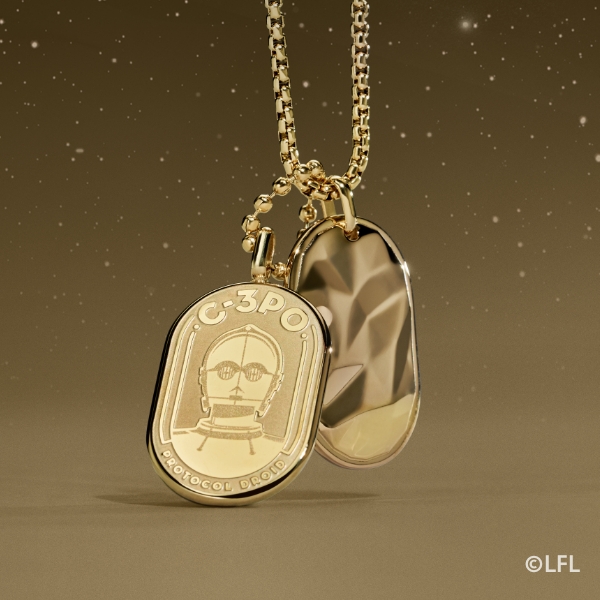 A gold-tone necklace with an engraving of C-3PO on an ID plaque