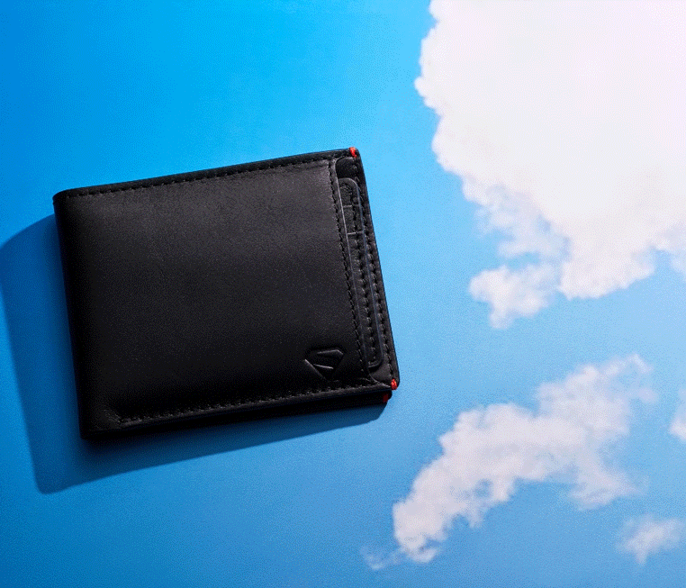 Black leather wallet that reveals a slide-out card case with a Superman illustration in his signature flying pose.