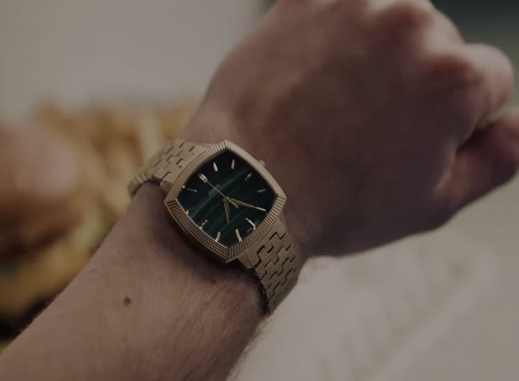 A close up of Nick's wrist featuring the stainless steel Machine Luxe watch with an aventurine dial.