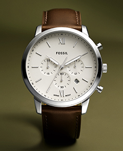 The classic Neutra watch in a gold-tone finish with a brown leather strap.