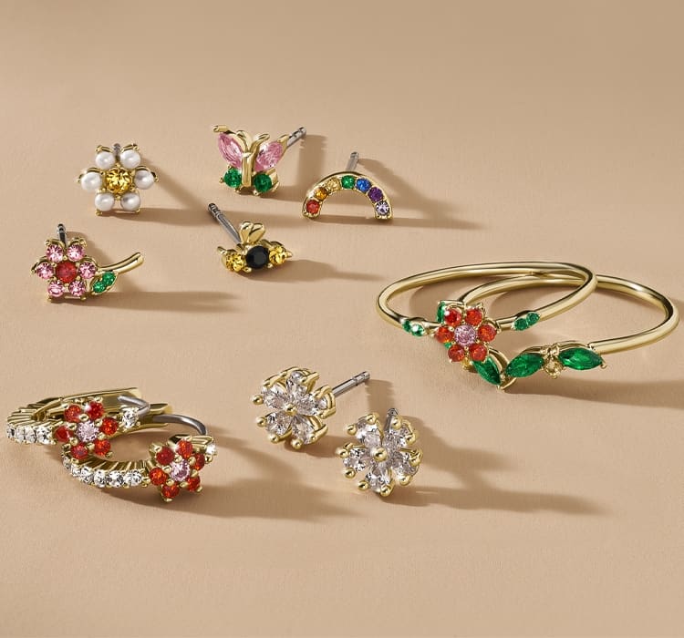 A GIF image of colourful crystal earrings and rings in garden-inspired floral designs.