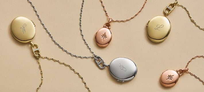 Five locket necklaces in gold-tone, rose gold-tone and silver-tone. 