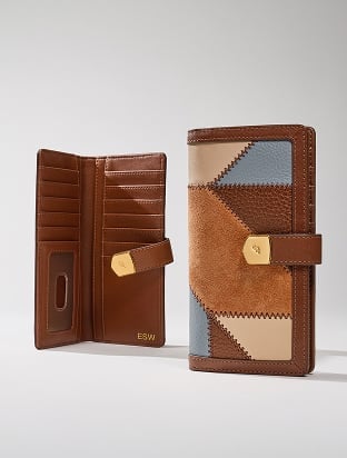 Two Fossil women's bifold wallets in blush pink and light brown leather.