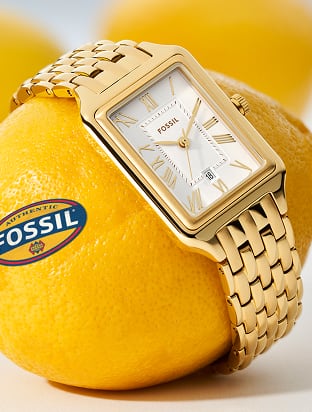 The Fossil Harlow chain bracelet watch is playfully placed over fresh lemons. 