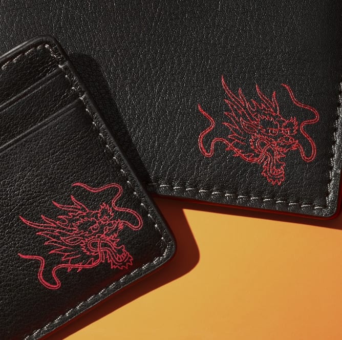 Black leather wallets embossed with a red dragon graphic.